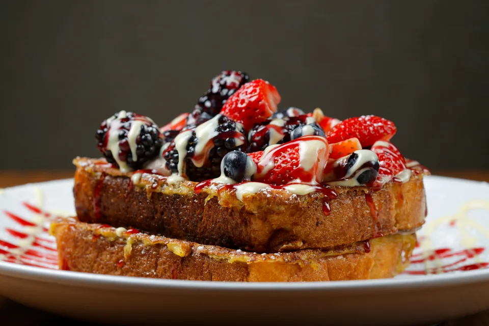 Thick French toast topped with fresh strawberries, blueberries and blackberries at Wildberry Pancakes & Cafe